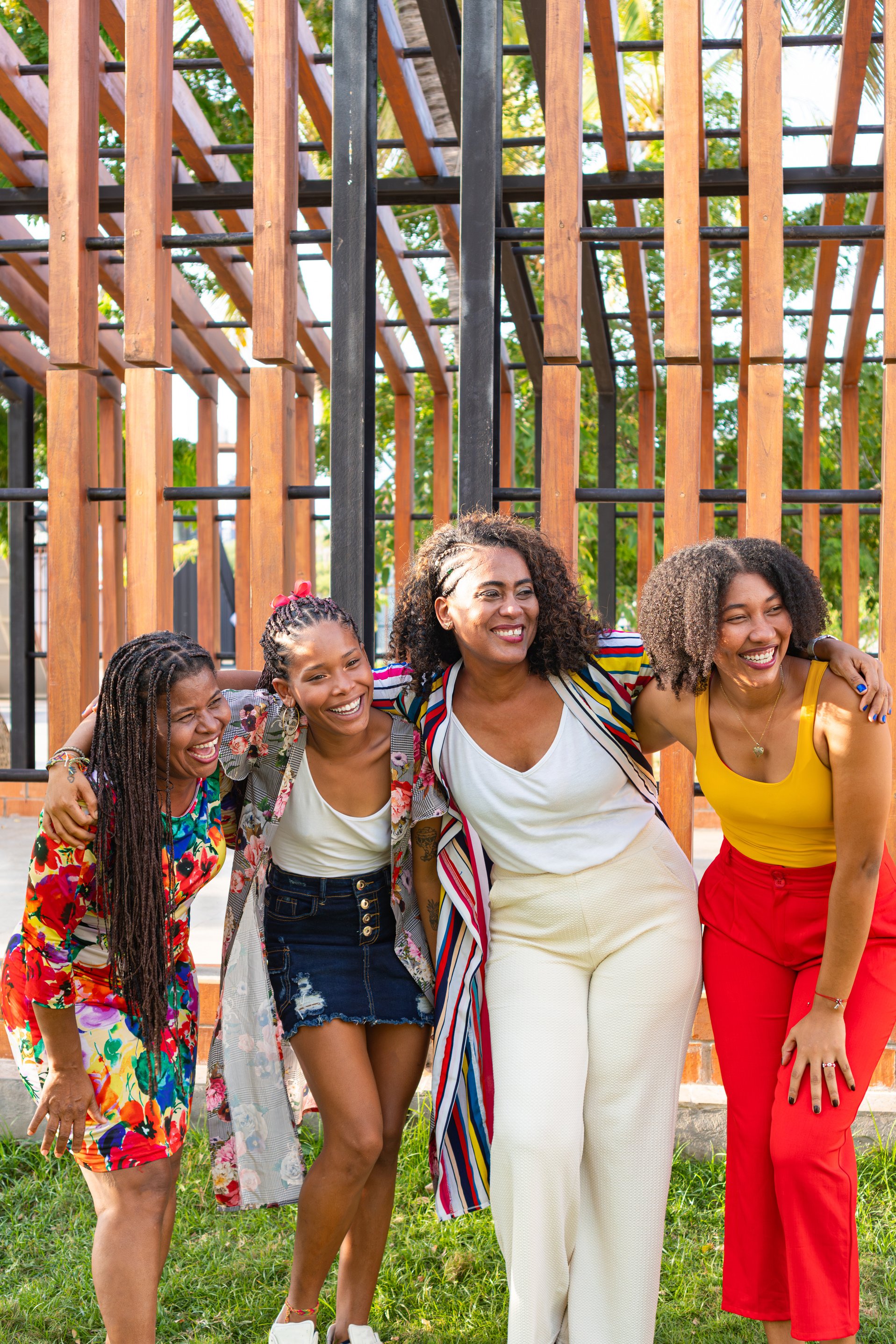 Warm embrace between joyful black women in the park